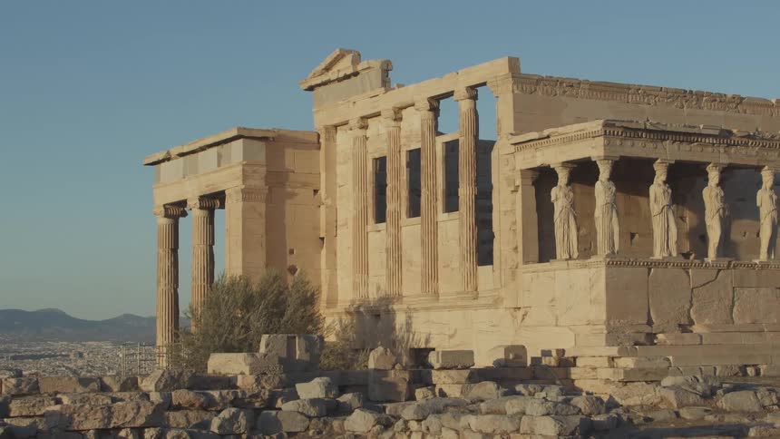 The parthenon stands majestically on a hilltop