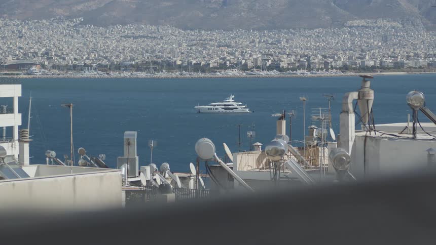 Large yacht at sea in an environment surrounded by an urban city