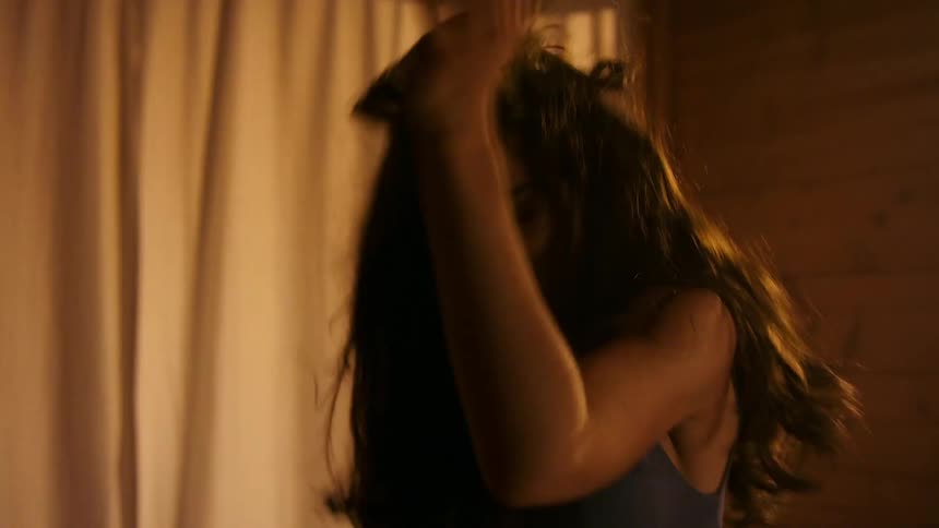 Girl flips her hair back while she dances