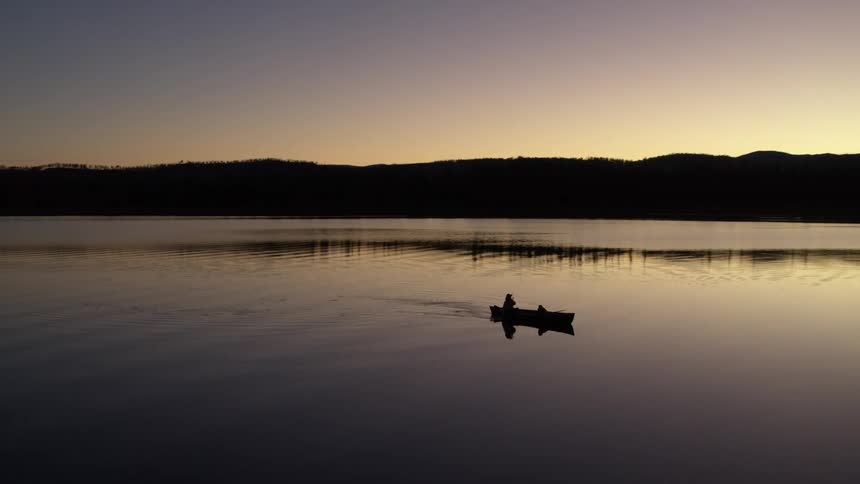 A person on a boat in a lake