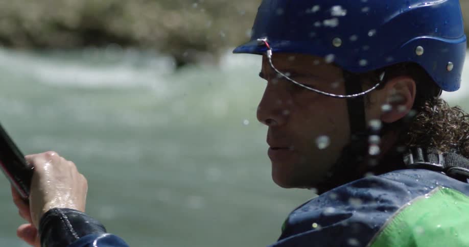 A man kayaks on a river