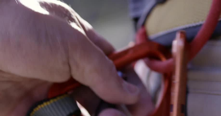 Person attaching a second carabiner to a loop
