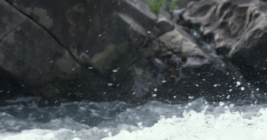Water splashes around the rocks ahead