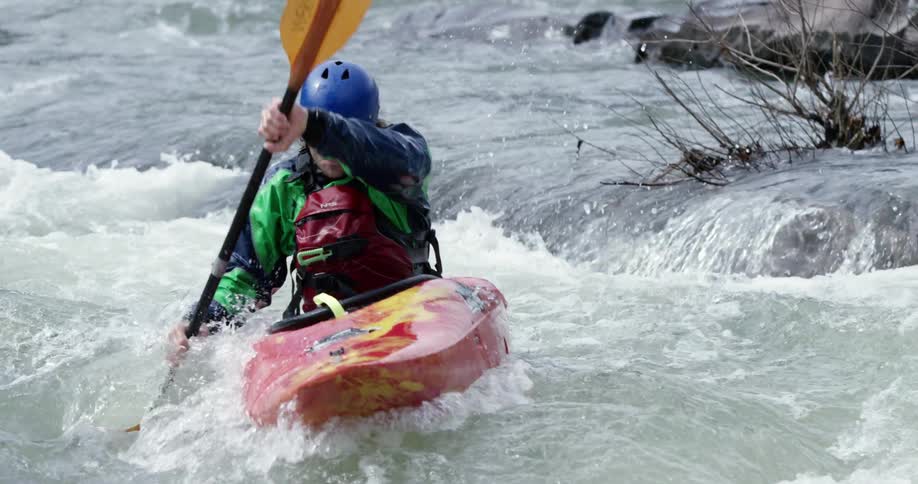 Kayaker maneuvering through some semi-rough waters