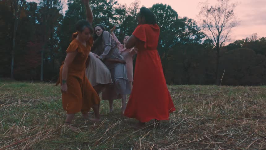 Women in dresses dancing in a natural area