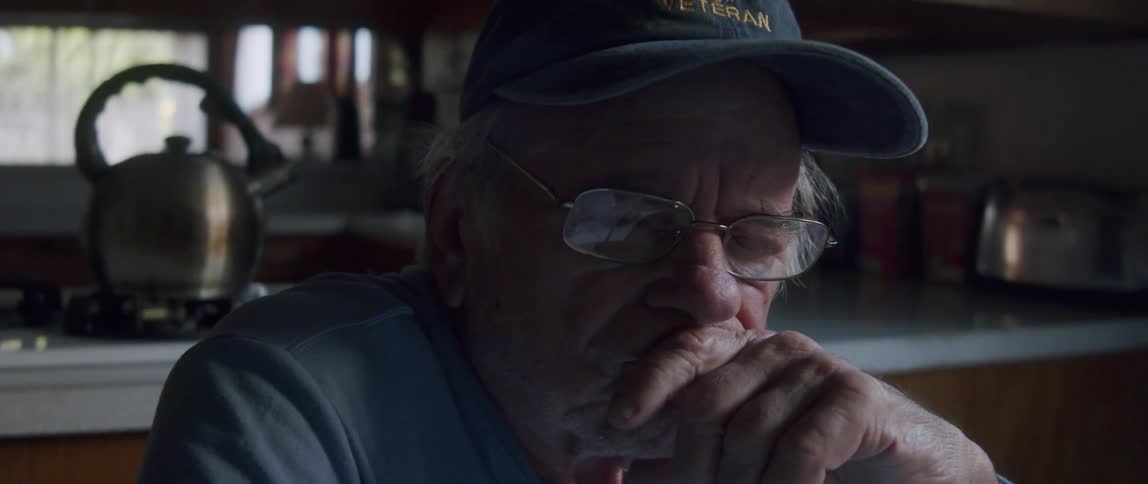 Close up of the face of an elderly man thinking in the kitchen at home