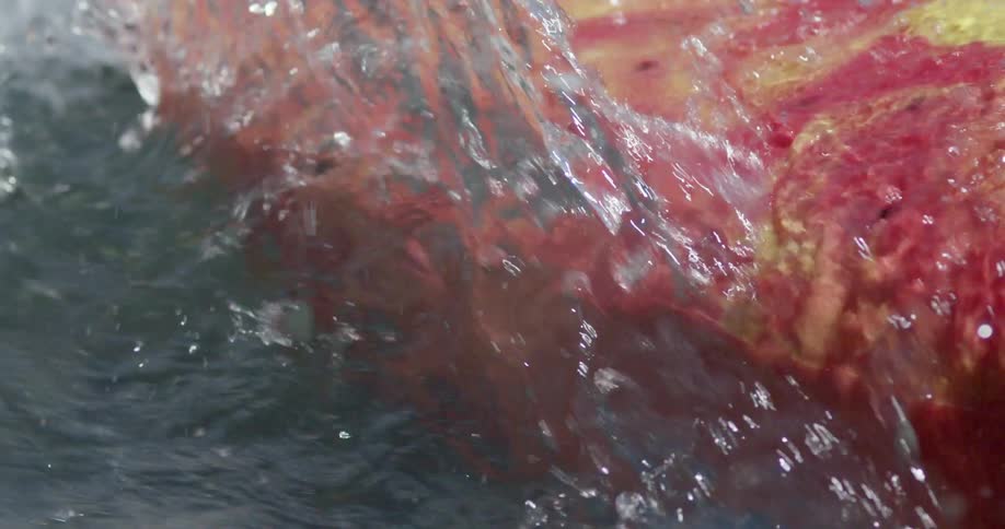 A close up view of a boat splashing through the water