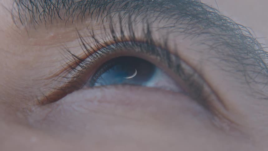 Close up of a mans eye opening