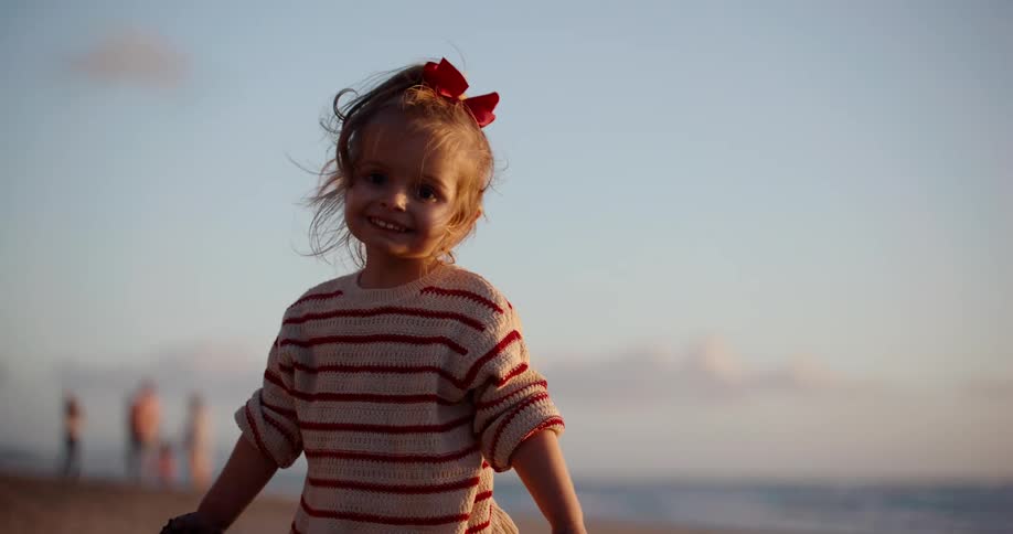 Child on the beach during sunset