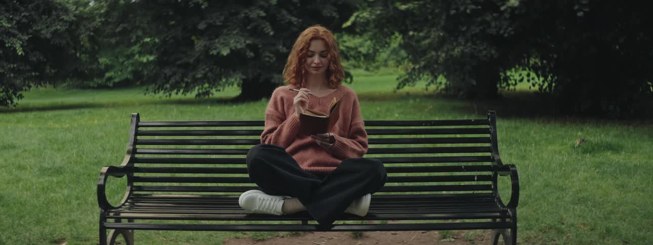 A clip of a lady sitting and studying