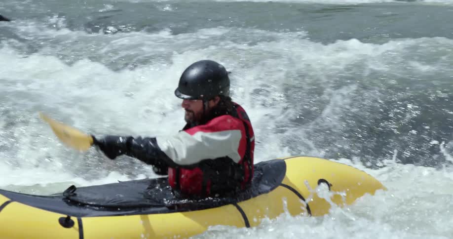 A kayaker paddles through rapids