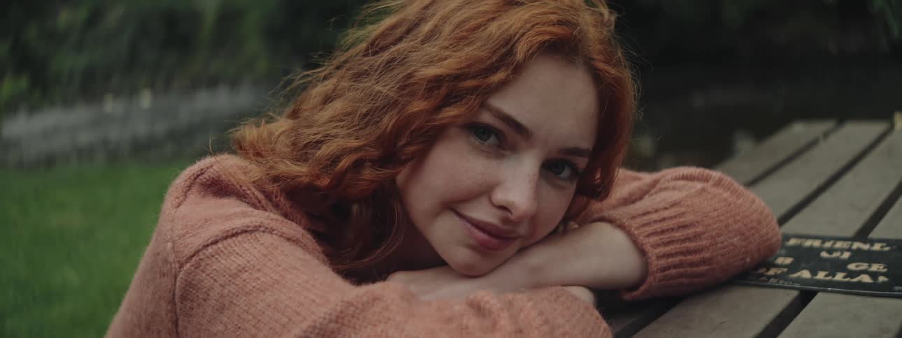 A clip of a lady putting on a knitwear