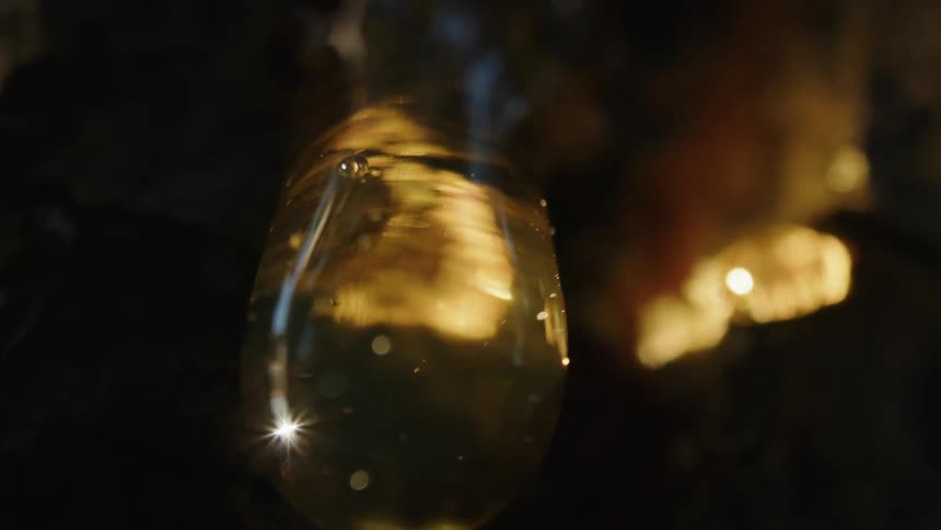 A water droplet reflects light as it falls