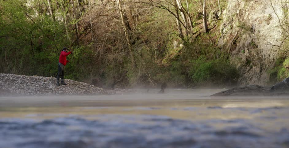 Man fly fishing from the river's bank