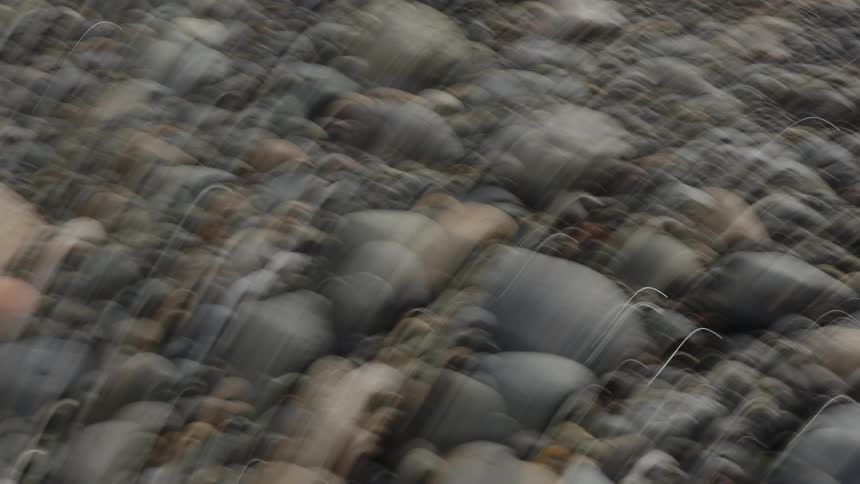 A nature area covered in polished rocks of various sizes and shapes
