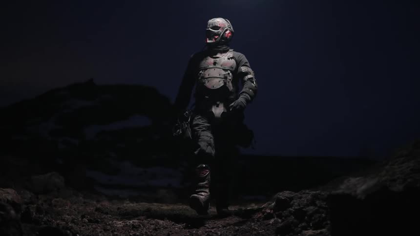 Person in armor walks in a mysterious night scene