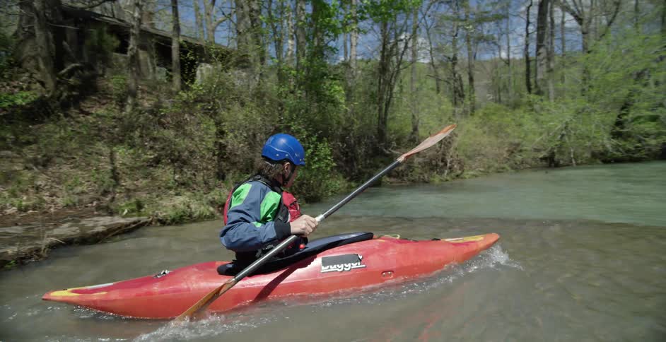 Person kayaking down the river