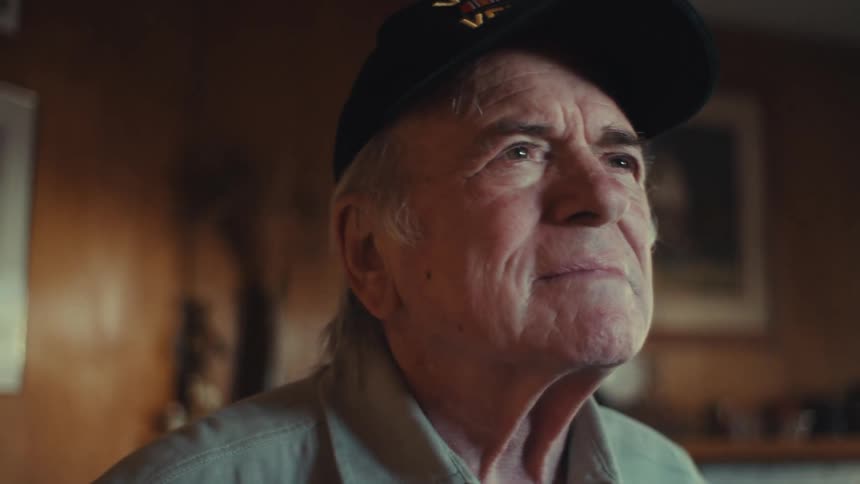 Portrait of an elderly man in an indoor space observing