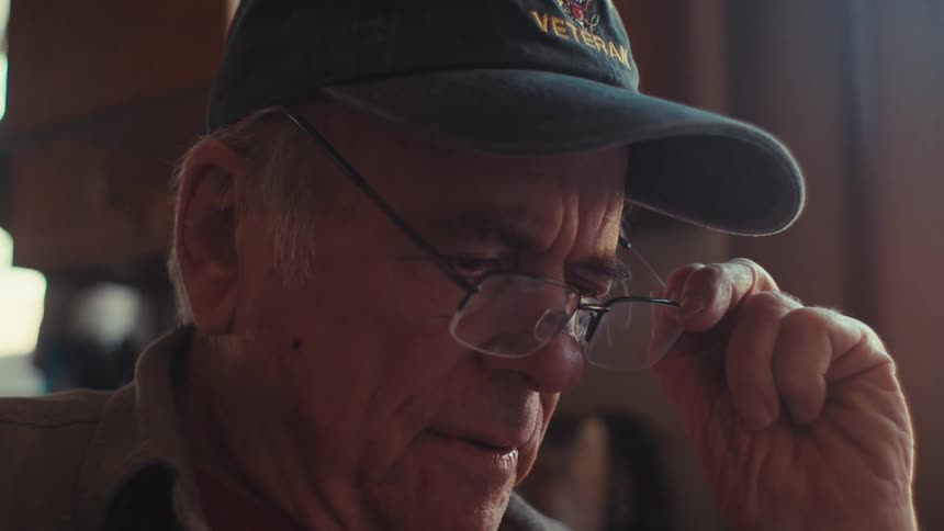 A close up clip of an elderly man contemplating