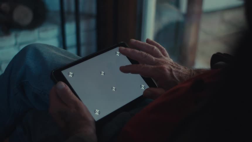 A clip of an elderly person operating a tablet