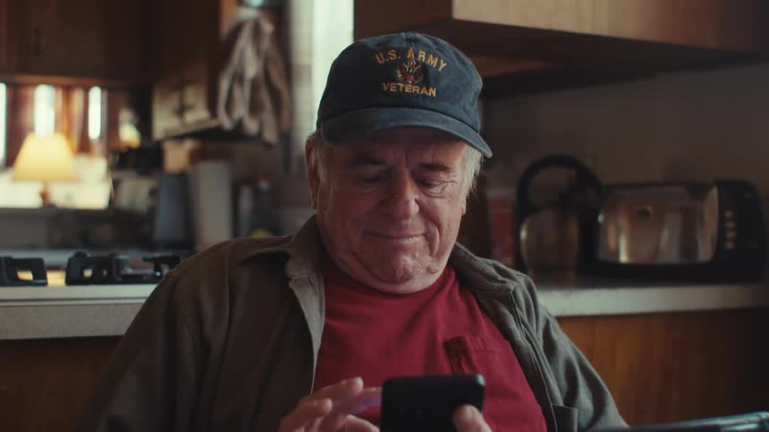 A man is typing on his cell phone