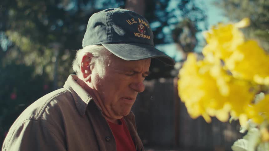 Elderly man in a backyard garden