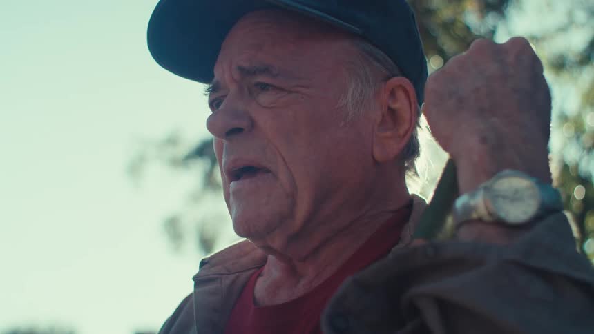 A man is holding a pole outside