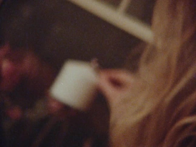 Woman in the kitchen striking a match and lighting a candle