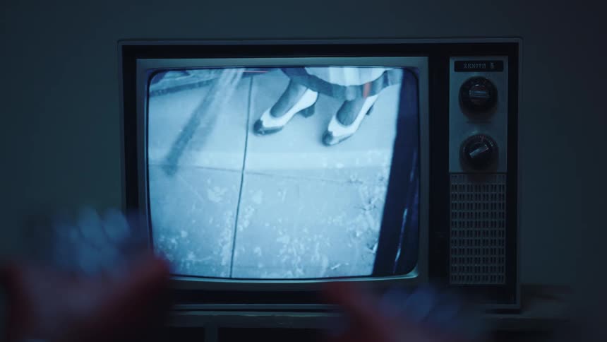 A clip of a film playing on a television