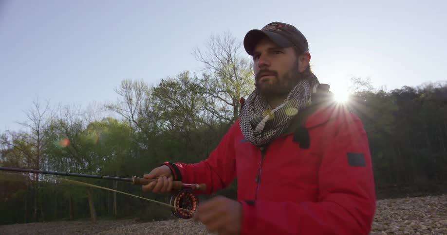 A man in red casts a fishing line