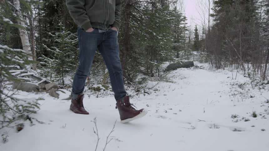 Man walking through snowy woods