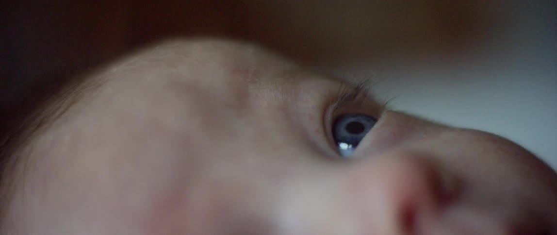 A view of a baby's nose and blue eye
