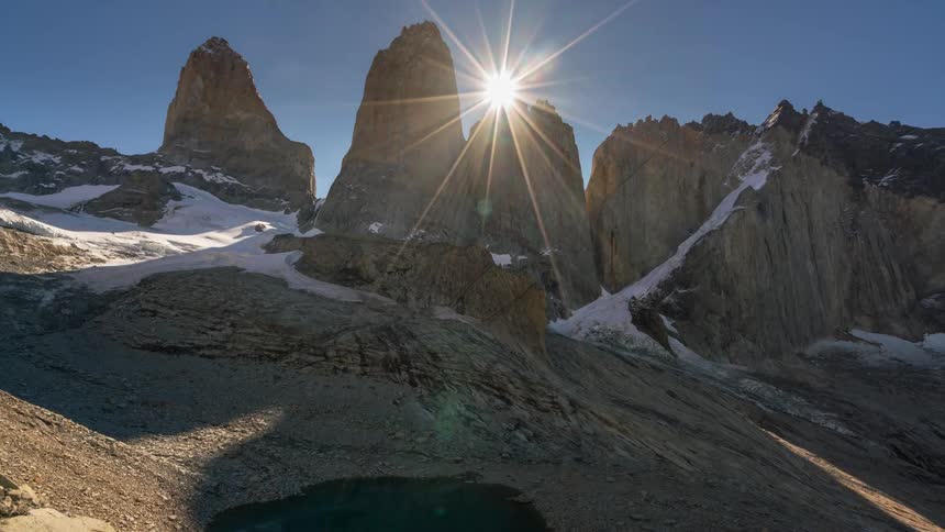 The sun sets behind the mountain