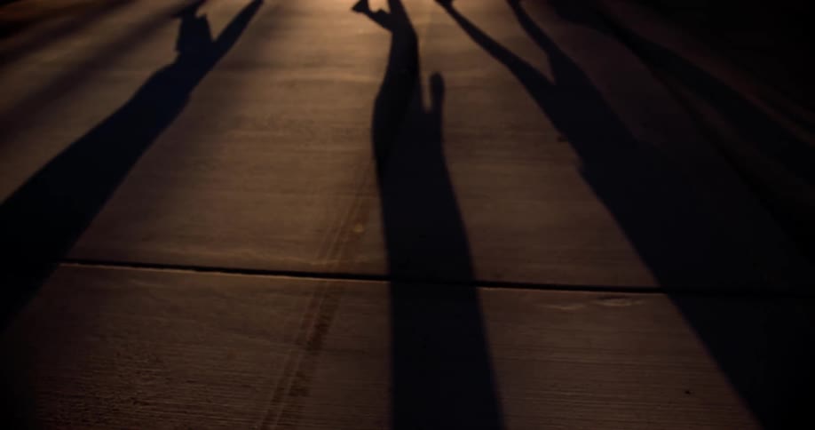 Elongated shadows cast on a floor