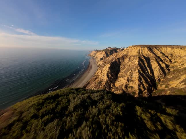 Mountains line the shore by the beach