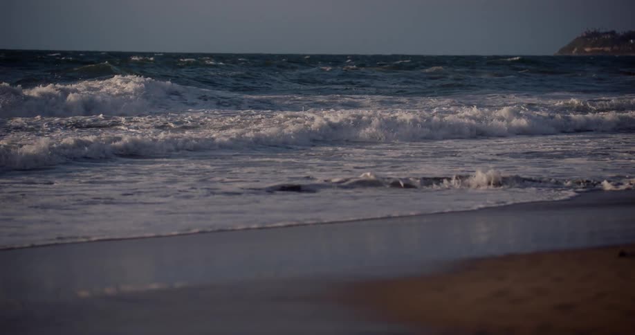 Sea waves rolling on the shore line on the beach