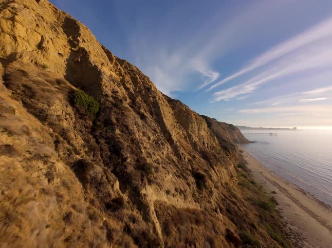 Mountains are near the beach at sunrise