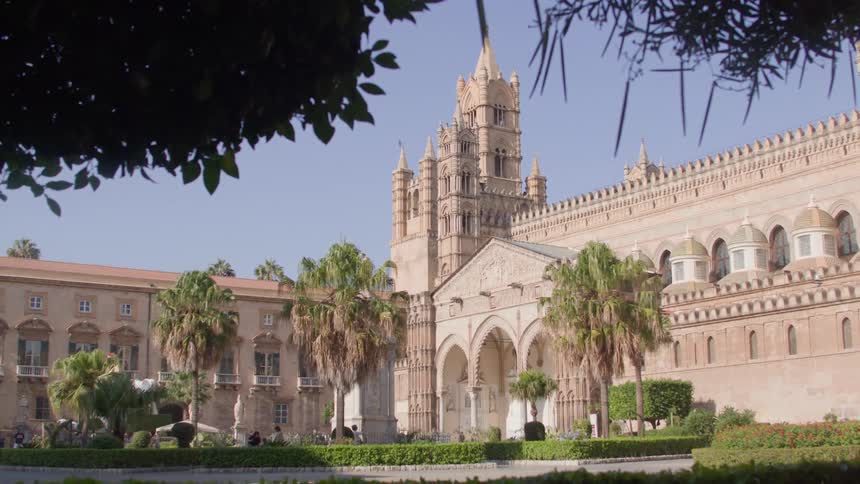 Grand ornate building with gothic architectural features including pointed arches and a prominent tower