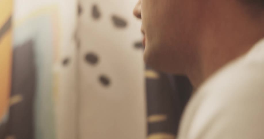 The face of a man who is washing his face in a sink using water and then he dries it using a towel