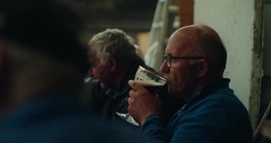 Men are drinking beer and talking outside