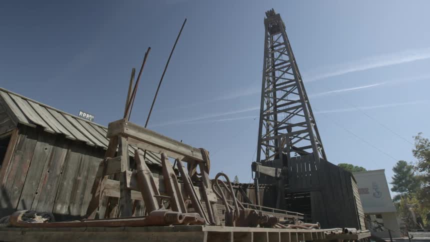 A work yard with scrap metal and a tower