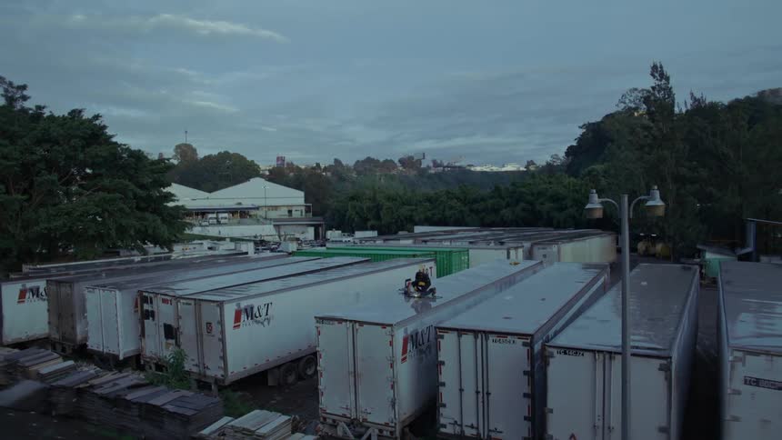 Person on the roof of a truck repairing with a tool