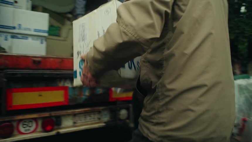 Elderly men loading boxes into a moving truck