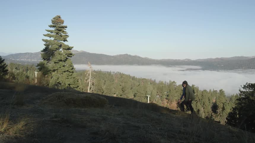 Two people hiking up a hill