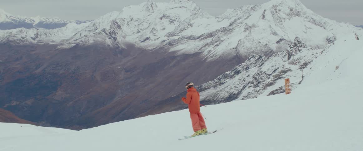 A person skiing with an epic mountain range in the distance