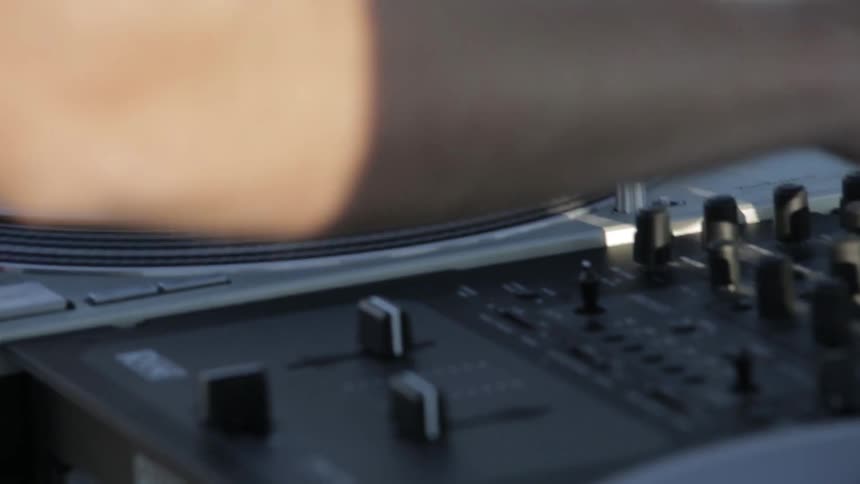 Man adjusts knobs on a turntable