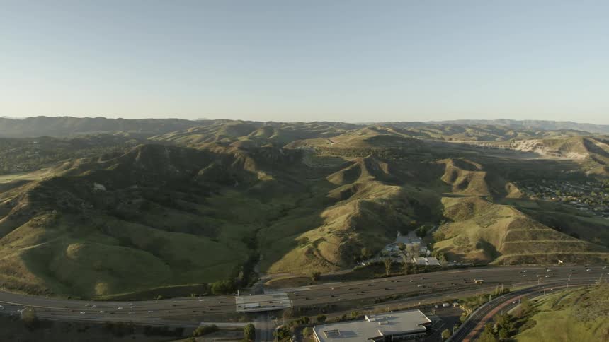 A busy freeway winds through a hilly area