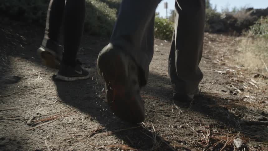 People walking outside on a dirt path