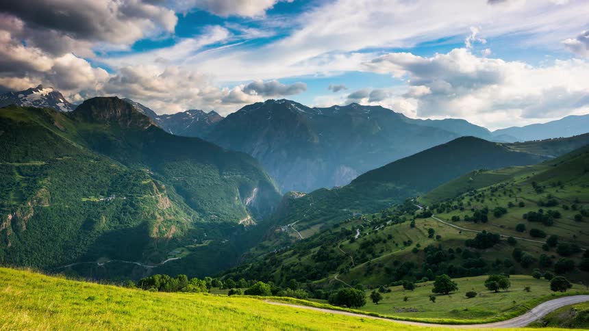 Clouds cast shadows onto mountains crossed by multiple highways