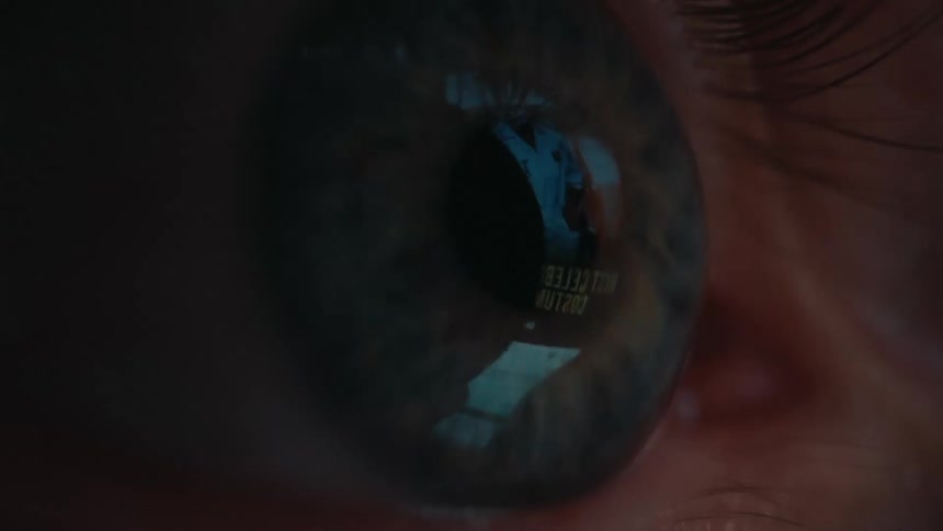 Extreme close up of a persons blue eye looking at a smartphone screen